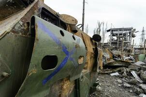 burnt tank and destroyed buildings of the Azovstal plant shop in Mariupol photo