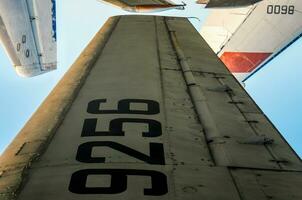 wing with tail number on the background of airplanes and blue sky photo