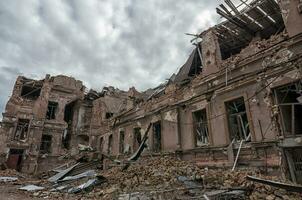 destroyed and burned houses in the city during the war in Ukraine photo