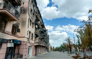 destroyed and burned houses in the city during the war in Ukraine photo