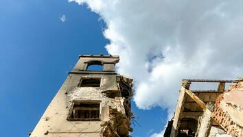 destroyed and burned houses in the city during the war in Ukraine photo