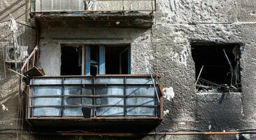 destroyed and burned houses in the city during the war in Ukraine photo