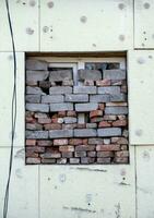 empty windows of a damaged house in Ukraine photo