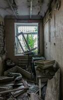 inside a destroyed house without people in an abandoned city in Ukraine photo