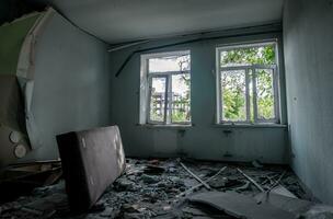 inside a destroyed house without people in an abandoned city in Ukraine photo