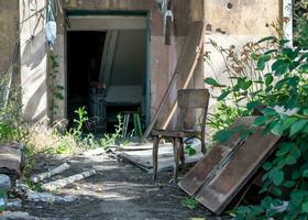 old broken door of a destroyed house in Ukraine photo