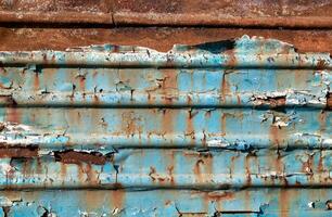 pattern rusty metal surface with remnants of blue paint photo