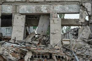 destroyed and burned houses in the city during the war in Ukraine photo