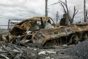 burnt tank and destroyed buildings of the Azovstal plant shop in Mariupol photo