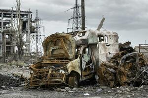 burnt cars and destroyed buildings of the workshop of the Azovstal plant in Mariupol photo