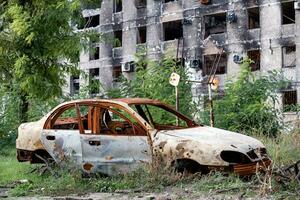 destroyed and burned houses in the city during the war in Ukraine photo