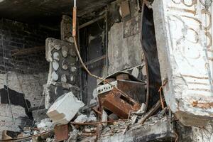 destroyed and burned houses in the city during the war in Ukraine photo