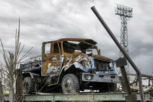 burnt car and destroyed buildings of the workshop of the Azovstal plant in Mariupol photo