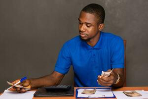 young african man doing his finances photo