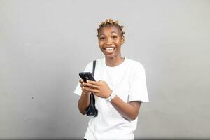 beautiful african woman smiling while using her mobile phone photo