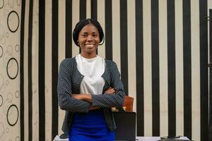 excited african business woman standing in the office photo