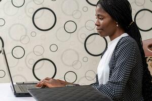 successful african businesswoman seriously focusing on her work photo