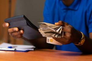 black man doing some financial calculations photo