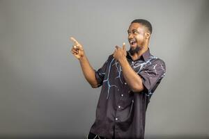 Overexcited young black guy raising fist up on white background, celebrating success. Happy African millennial man sharing positive emotions, copy space, empty space photo