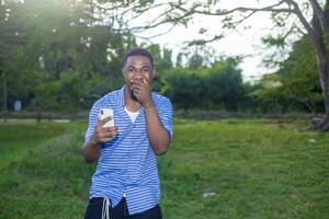 over excited man in casual clothes use his mobile phone photo