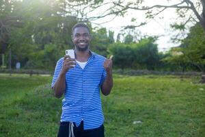 Happy, excited and success while reading phone message with business man celebrating being a winner and cheering for investment growth outside. photo