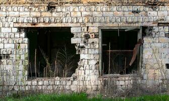 empty windows of a damaged house in Ukraine photo