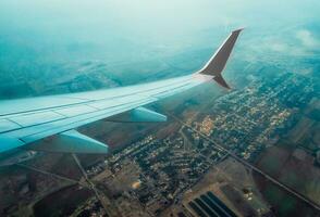 wing of a flying civil airliner over the city of Georgia photo