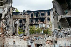 destroyed and burned houses in the city during the war in Ukraine photo