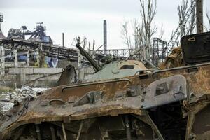 burnt tank and destroyed buildings of the Azovstal plant shop in Mariupol photo