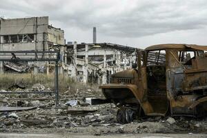 burnt cars and destroyed buildings of the workshop of the Azovstal plant in Mariupol photo