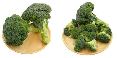 broccoli on wooden plate over white background photo