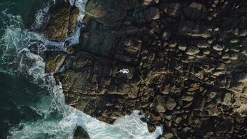 top view from a drone girl lies on the rocks video