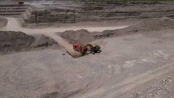 excavator loads gravel into truck asphalt quarry video