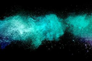 Abstract multicolored powder explosion on black background. Red and blue dust particles splattered on background. photo