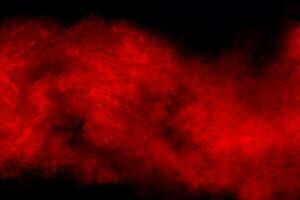 Red powder explosion cloud on black background. photo