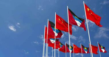 Antigua and Barbuda and China Flags Waving Together in the Sky, Seamless Loop in Wind, Space on Left Side for Design or Information, 3D Rendering video