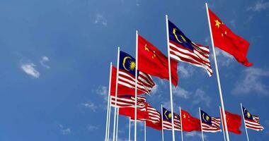 Malaysia and China Flags Waving Together in the Sky, Seamless Loop in Wind, Space on Left Side for Design or Information, 3D Rendering video