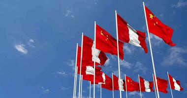 Peru and China Flags Waving Together in the Sky, Seamless Loop in Wind, Space on Left Side for Design or Information, 3D Rendering video