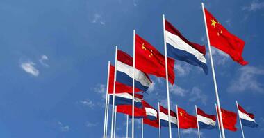Netherlands and China Flags Waving Together in the Sky, Seamless Loop in Wind, Space on Left Side for Design or Information, 3D Rendering video