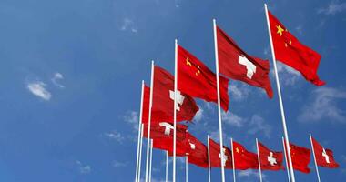 Switzerland and China Flags Waving Together in the Sky, Seamless Loop in Wind, Space on Left Side for Design or Information, 3D Rendering video