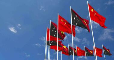 Papua New Guinea and China Flags Waving Together in the Sky, Seamless Loop in Wind, Space on Left Side for Design or Information, 3D Rendering video