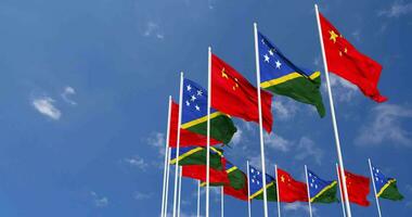 Solomon Islands and China Flags Waving Together in the Sky, Seamless Loop in Wind, Space on Left Side for Design or Information, 3D Rendering video