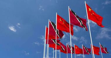 Trinidad and Tobago and China Flags Waving Together in the Sky, Seamless Loop in Wind, Space on Left Side for Design or Information, 3D Rendering video