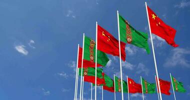 Turkmenistan and China Flags Waving Together in the Sky, Seamless Loop in Wind, Space on Left Side for Design or Information, 3D Rendering video