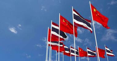 Thailand and China Flags Waving Together in the Sky, Seamless Loop in Wind, Space on Left Side for Design or Information, 3D Rendering video