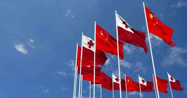 Tonga and China Flags Waving Together in the Sky, Seamless Loop in Wind, Space on Left Side for Design or Information, 3D Rendering video