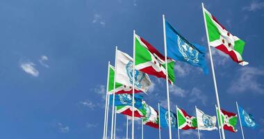 Burundi and United Nations, UN Flags Waving Together in the Sky, Seamless Loop in Wind, Space on Left Side for Design or Information, 3D Rendering video