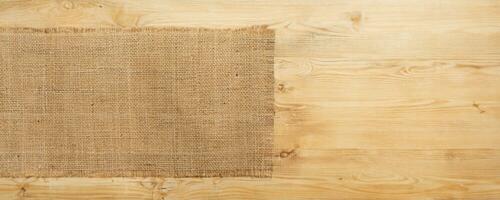 burlap hessian sacking on wooden background photo