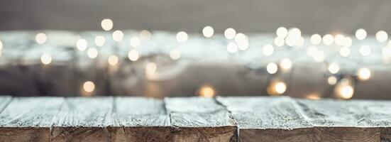 Christmas holiday background with empty wooden table top over festive bokeh light decorate. photo
