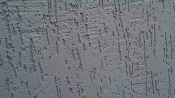 Slow motion footage of the rare snowflakes falling against dark decorative wall. Concept video